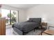 This bedroom features a modern bed set, wood floors, and a bright window with beautiful views at 1836 N Crystal Lake Dr # 104, Lakeland, FL 33801