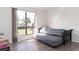 Bright bedroom featuring wood floors, trundle bed, and a large window with views of the community at 1836 N Crystal Lake Dr # 104, Lakeland, FL 33801