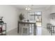 Bright dining area with a wood table, stools and a sliding glass door leading to the outside at 1836 N Crystal Lake Dr # 104, Lakeland, FL 33801
