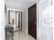 Bright entryway featuring tile floors, mirrored closet, and a modern front door with keyless entry at 1836 N Crystal Lake Dr # 104, Lakeland, FL 33801