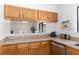 Kitchen with oak cabinets, stainless steel appliances, and a pass-through window to the dining area at 1836 N Crystal Lake Dr # 104, Lakeland, FL 33801
