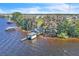 Waterfront home with dock, boathouse and a large lot with mature trees in a quiet neighborhood at 18951 Lake Pickett Rd, Orlando, FL 32820