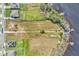 Overhead view of a sprawling waterfront lot, close to neighborhood, lush trees, and a private dock at 18951 Lake Pickett Rd, Orlando, FL 32820