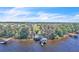 Waterfront home with dock, boat house, and a large wooded lot with mature trees at 18951 Lake Pickett Rd, Orlando, FL 32820