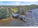 Beautiful lakefront property showcasing the home, boat dock, and tranquil lake setting at 18951 Lake Pickett Rd, Orlando, FL 32820