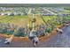 Large waterfront lot with mature trees and a home with a boathouse and dock on the water at 18951 Lake Pickett Rd, Orlando, FL 32820
