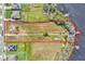 Overhead view of a sprawling waterfront lot, close to neighborhood, lush trees, and a private dock at 18951 Lake Pickett Rd, Orlando, FL 32820