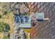 Aerial shot featuring the home's roof, dock, and boat house at 18951 Lake Pickett Rd, Orlando, FL 32820