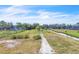 Large lot with waterfront access featuring mature trees and a small shed in the backyard at 18951 Lake Pickett Rd, Orlando, FL 32820