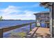 Lakeside dock with wooden railing offering scenic lake views at 18951 Lake Pickett Rd, Orlando, FL 32820