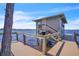 Dock featuring stairs to a boathouse with lake views at 18951 Lake Pickett Rd, Orlando, FL 32820