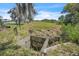 Drainage culvert on a large lot with mature trees and community homes nearby at 18951 Lake Pickett Rd, Orlando, FL 32820