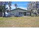 Charming lakefront home featuring a screened porch and surrounded by mature trees at 18951 Lake Pickett Rd, Orlando, FL 32820
