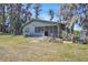 Quaint lake house surrounded by lush trees and greenery at 18951 Lake Pickett Rd, Orlando, FL 32820