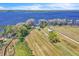 Aerial view of a waterfront lot with mature trees, a small structure and water access at 18951 Lake Pickett Rd, Orlando, FL 32820