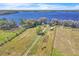 Aerial view of a waterfront lot with mature trees, a small structure and water access at 18951 Lake Pickett Rd, Orlando, FL 32820
