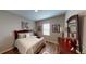 Cozy bedroom featuring a queen bed, wood floors, and stylish decor at 2050 1St Ave, Deland, FL 32724