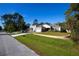 A single Gathering house with well-maintained lawn, beautiful landscaping and brick retention wall at 2050 1St Ave, Deland, FL 32724