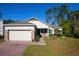 Charming single Gathering home with an attached two car garage and brick paved driveway and walkway at 2050 1St Ave, Deland, FL 32724