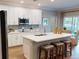 A kitchen with white cabinets, stainless steel appliances, quartz countertops, and a center island at 2050 1St Ave, Deland, FL 32724