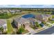 Aerial view of a home with a screened pool, pond view, and lush landscaping, offering a serene setting at 2136 Crofton Ave, Davenport, FL 33837