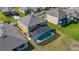 An aerial view showing a home with a screened pool enclosure, set in a well-maintained neighborhood at 2136 Crofton Ave, Davenport, FL 33837