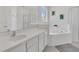 Bathroom featuring tub, shower, and dual sink vanity with ample counter space at 2136 Crofton Ave, Davenport, FL 33837