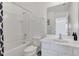 Bathroom with a shower and tub combo, vanity, and tiled walls at 2136 Crofton Ave, Davenport, FL 33837