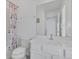 Bathroom with white vanity, matching floral shower curtain and a mirror at 2136 Crofton Ave, Davenport, FL 33837