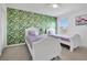 Bright bedroom with patterned wallpaper accent wall and matching flamingo artwork at 2136 Crofton Ave, Davenport, FL 33837