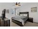 Bedroom features a wood accent wall, ceiling fan, and two windows at 2136 Crofton Ave, Davenport, FL 33837