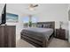 Bright bedroom featuring a wooden bed frame, two windows, and tasteful decor at 2136 Crofton Ave, Davenport, FL 33837