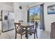 Eat-in kitchen featuring stainless steel refrigerator and view of the pool area at 2136 Crofton Ave, Davenport, FL 33837