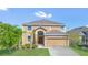 Beautiful two-story home with a manicured lawn, a two-car garage, and a welcoming entrance at 2136 Crofton Ave, Davenport, FL 33837