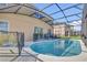 Screened in backyard pool area with patio furniture and ample seating at 2136 Crofton Ave, Davenport, FL 33837