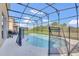 A screened pool with a safety fence offers a refreshing escape within a private backyard setting at 2136 Crofton Ave, Davenport, FL 33837