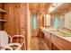 Bathroom featuring wood paneling and a long vanity at 220 Wekiva Park Drive, Sanford, FL 32771