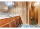 Bathroom featuring wood paneling, blue accents, and a large mirror at 220 Wekiva Park Drive, Sanford, FL 32771