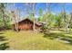 Charming home exterior featuring natural landscaping and mature trees on a sunny day at 220 Wekiva Park Drive, Sanford, FL 32771