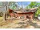 Rustic wooden home with unique architectural features blends seamlessly with its natural surroundings at 220 Wekiva Park Drive, Sanford, FL 32771