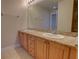 Bathroom with a double sink vanity featuring a granite countertop and decorative hardware at 225 W Seminole Blvd # 213, Sanford, FL 32771