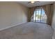 Bedroom featuring neutral carpet and sliding glass doors that open to a balcony at 225 W Seminole Blvd # 213, Sanford, FL 32771