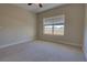 Bright bedroom features neutral carpeting, ceiling fan, and a window with natural light at 225 W Seminole Blvd # 213, Sanford, FL 32771