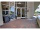 Building entrance with glass doors and windows, bench seating and brick pavers at 225 W Seminole Blvd # 213, Sanford, FL 32771