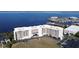 An aerial view of the white condo building and expansive marina on the water at 225 W Seminole Blvd # 213, Sanford, FL 32771