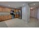 Well-lit kitchen features stainless steel appliances, light brown cabinets, and granite countertops at 225 W Seminole Blvd # 213, Sanford, FL 32771