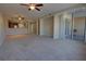 Large living room featuring carpet floors, ceiling fans, and access to a balcony at 225 W Seminole Blvd # 213, Sanford, FL 32771
