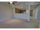 Spacious living room with carpet flooring, ceiling fans, and an open view of the kitchen at 225 W Seminole Blvd # 213, Sanford, FL 32771
