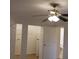 Bedroom features a ceiling fan, closet, and an attached bathroom at 2548 Oak Park Way # 102, Orlando, FL 32822