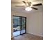 Bright room featuring a ceiling fan and sliding doors to the outdoor patio at 2548 Oak Park Way # 102, Orlando, FL 32822